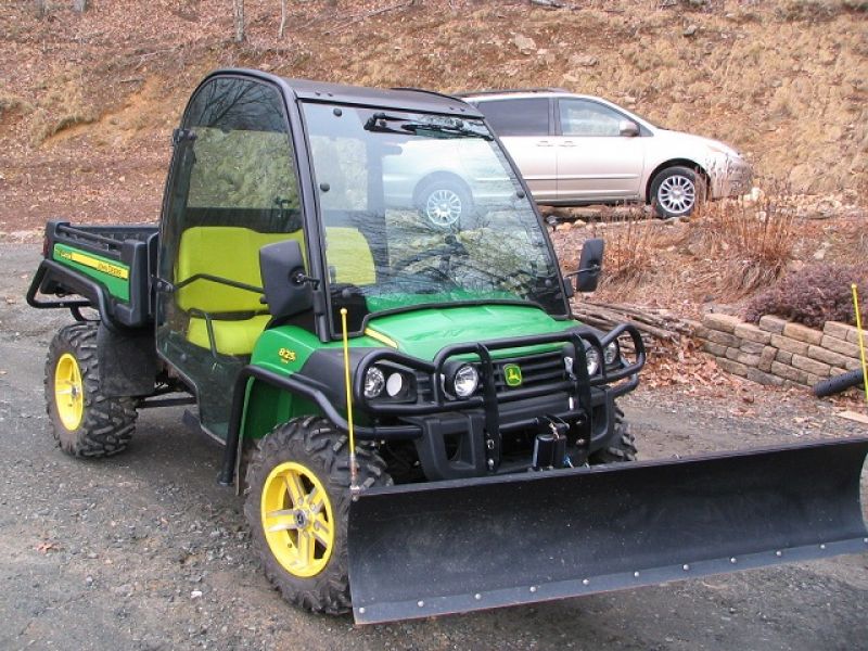 = $4,250 = 2011 John Deere Gator 825i w/ Plow
